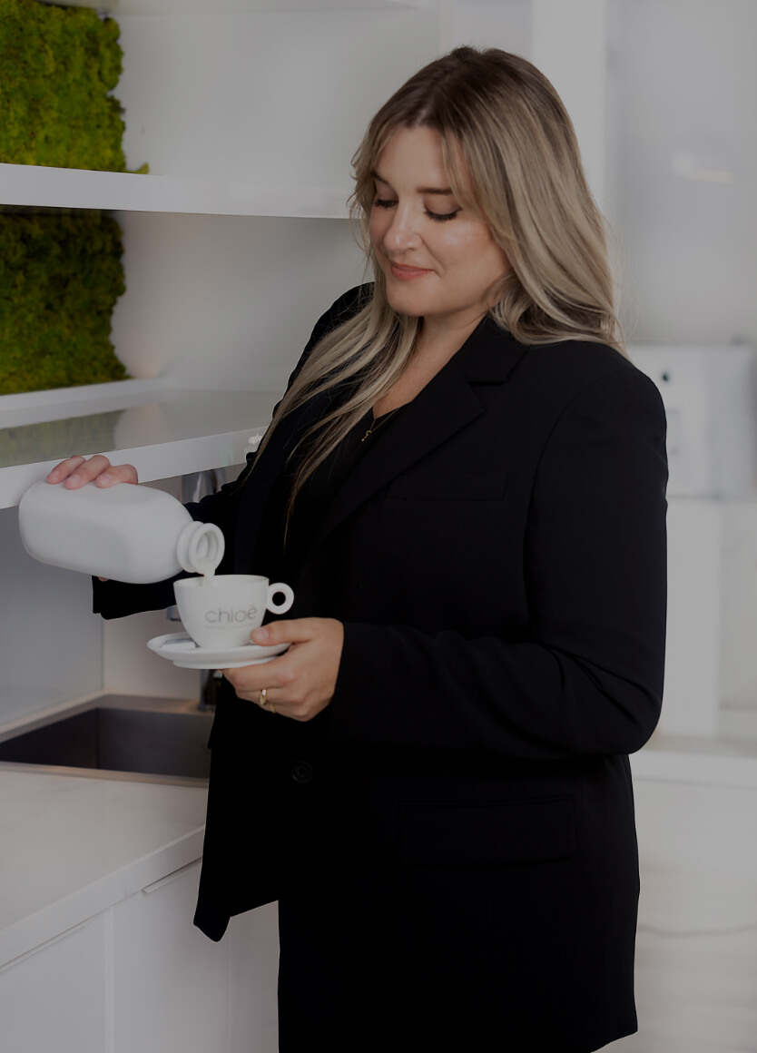 Medical receptionist Karine Leduc preparing a coffee for a patient in the waiting room of Clinique Chloé