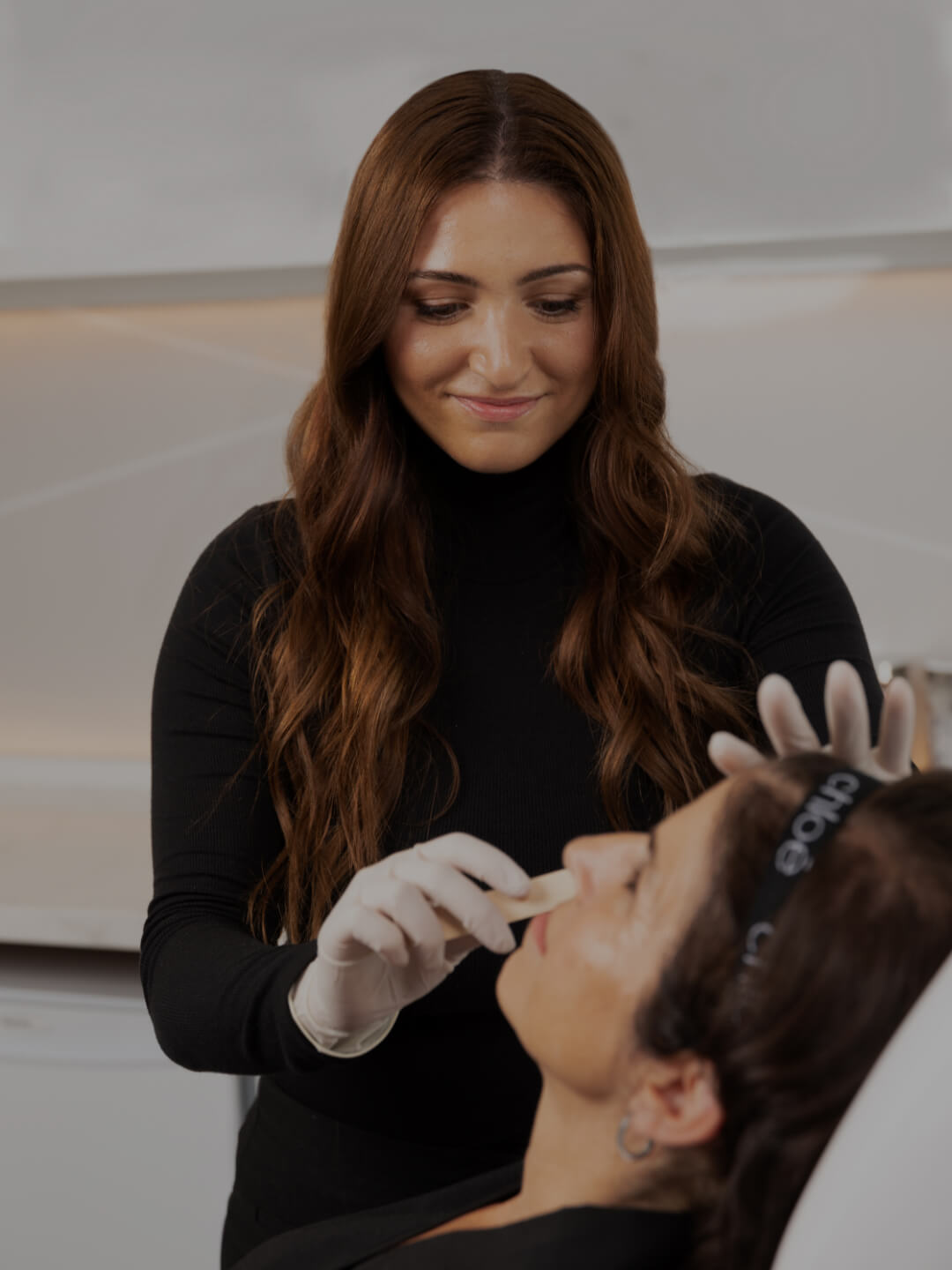 Medico-aesthetic technician Sonia D'Antico applying gel to her patient's face before an IPL treatment