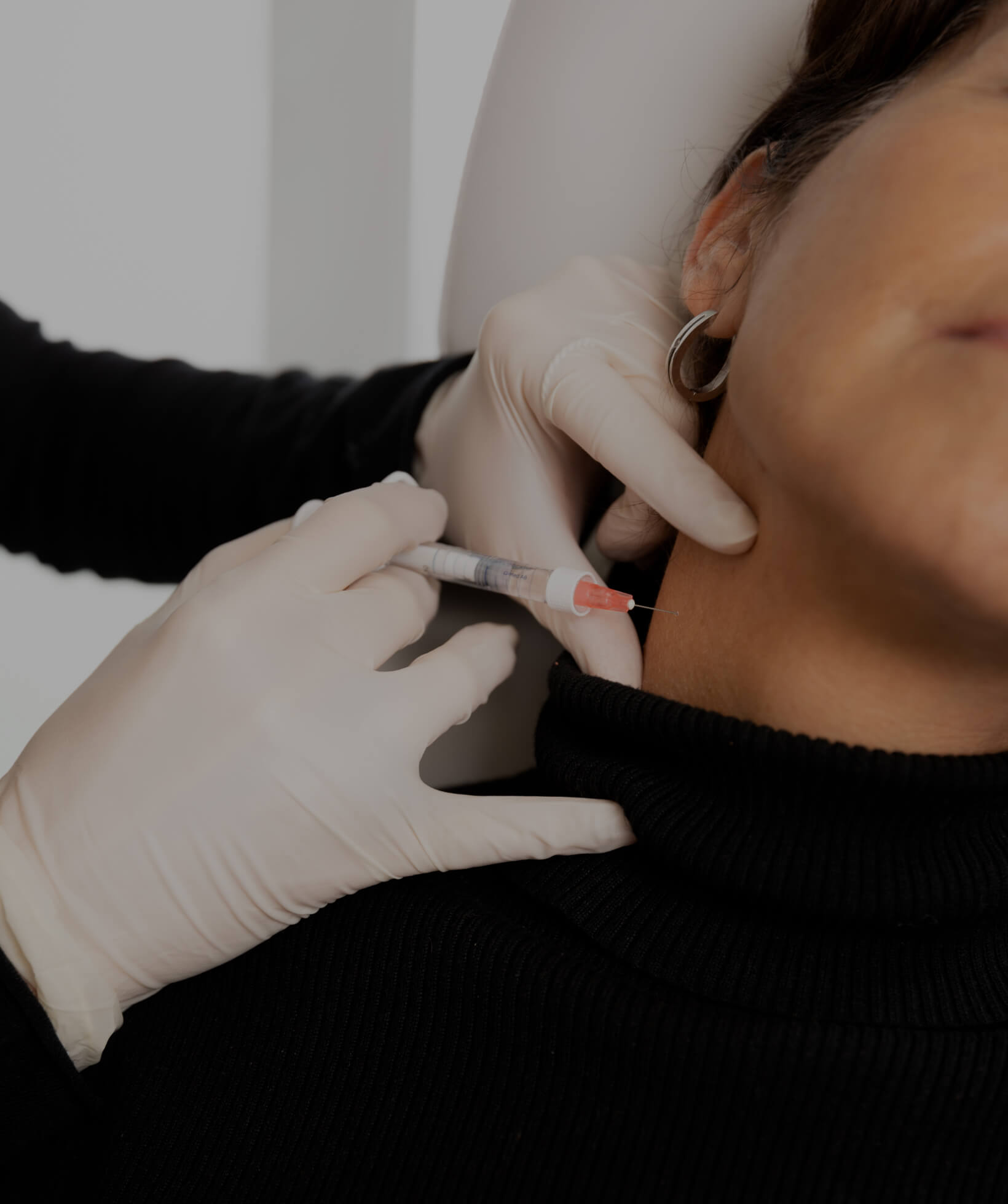 Un médecin de la Clinique Chloé pratiquant des injections de Skinboosters dans le cou d'une patiente