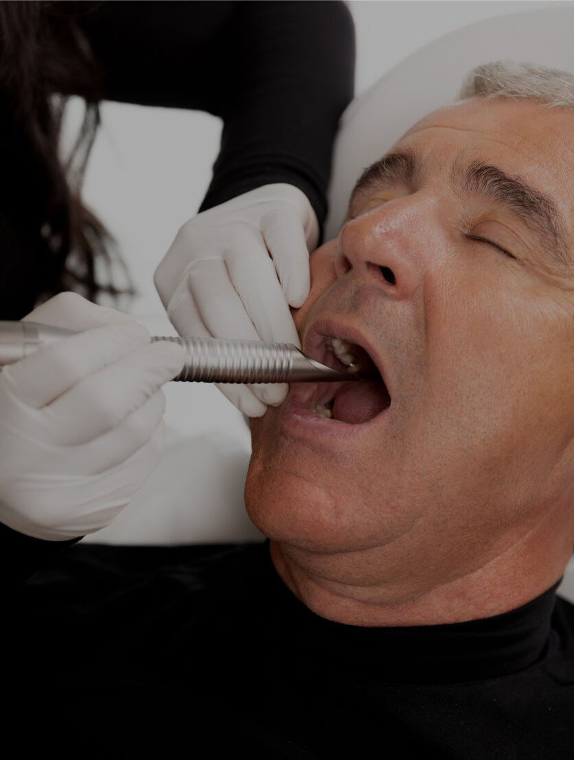 A Clinique Chloé medical aesthetic technician performing a NightLase intraoral laser treatment in a patient's mouth