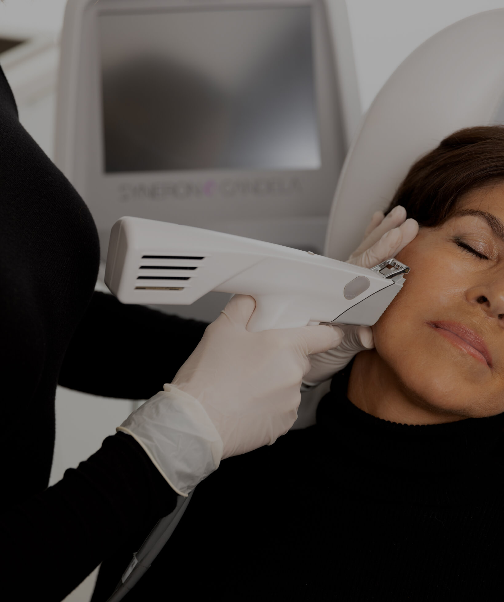 A nurse at Clinique Chloé treating a patient's face with the Profound radiofrequency microneedling device