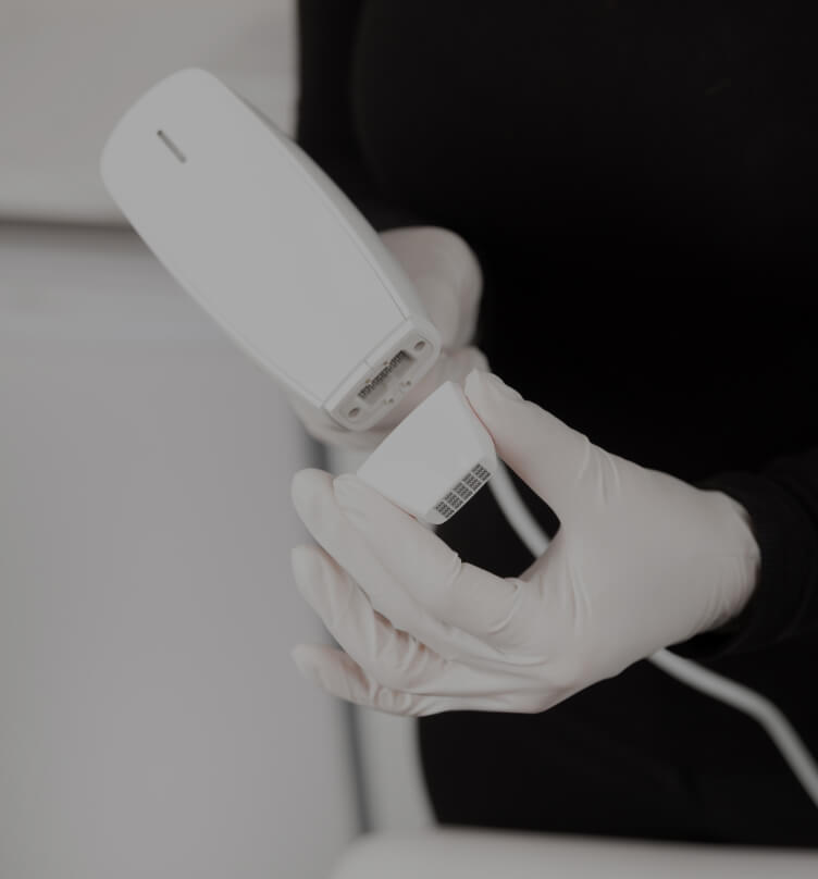 Technician connecting a Venus Viva tip to the handpiece of the medical aesthetic device