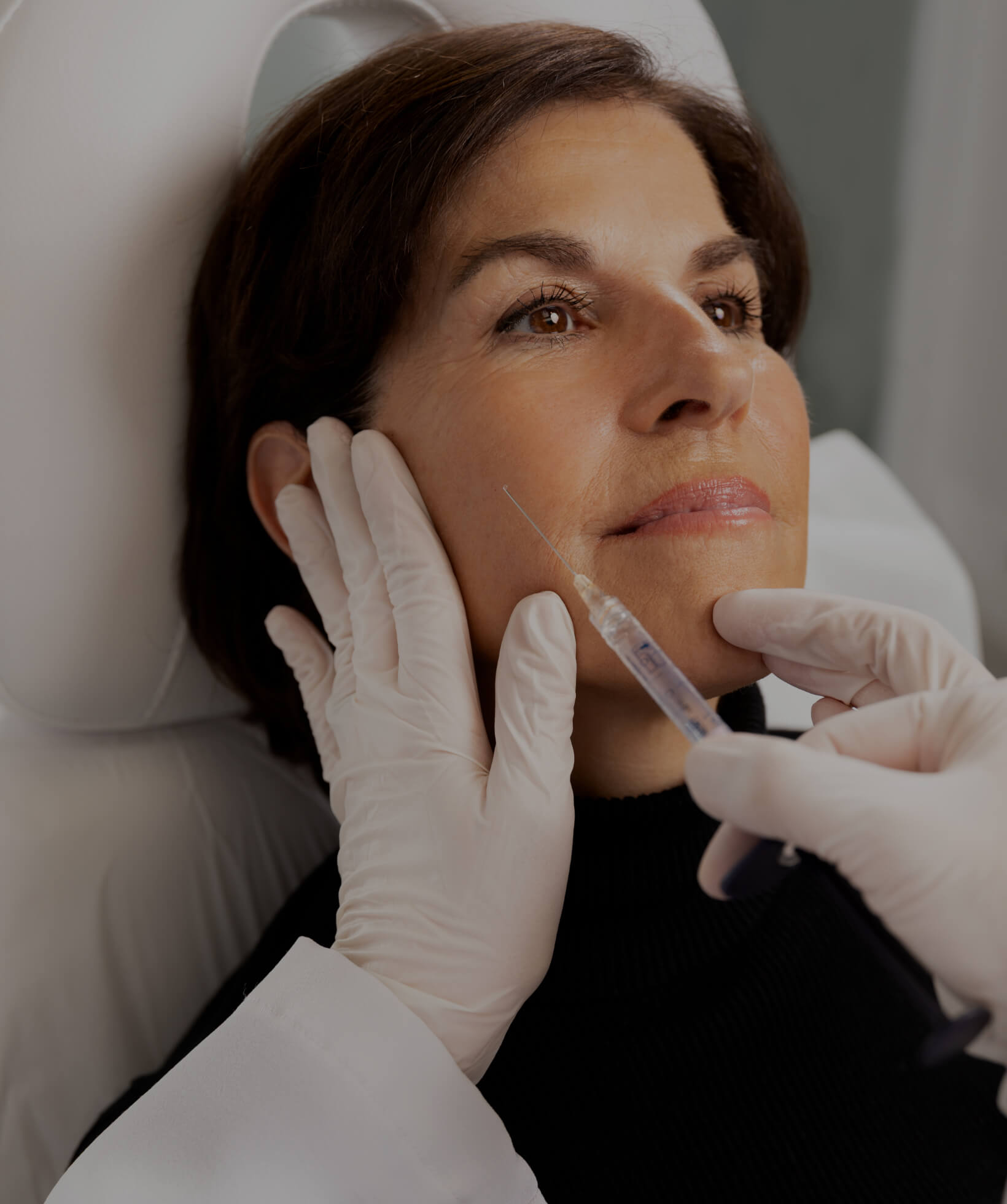 Dr. Chloé Sylvestre performing dermal filler injections in a female patient's cheekbones