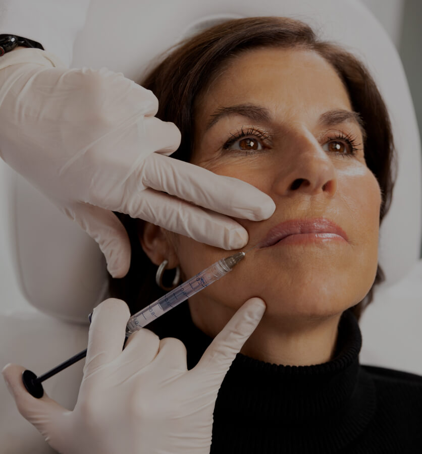 Dr. Chloé Sylvestre performing dermal filler injections in a female patient's lips