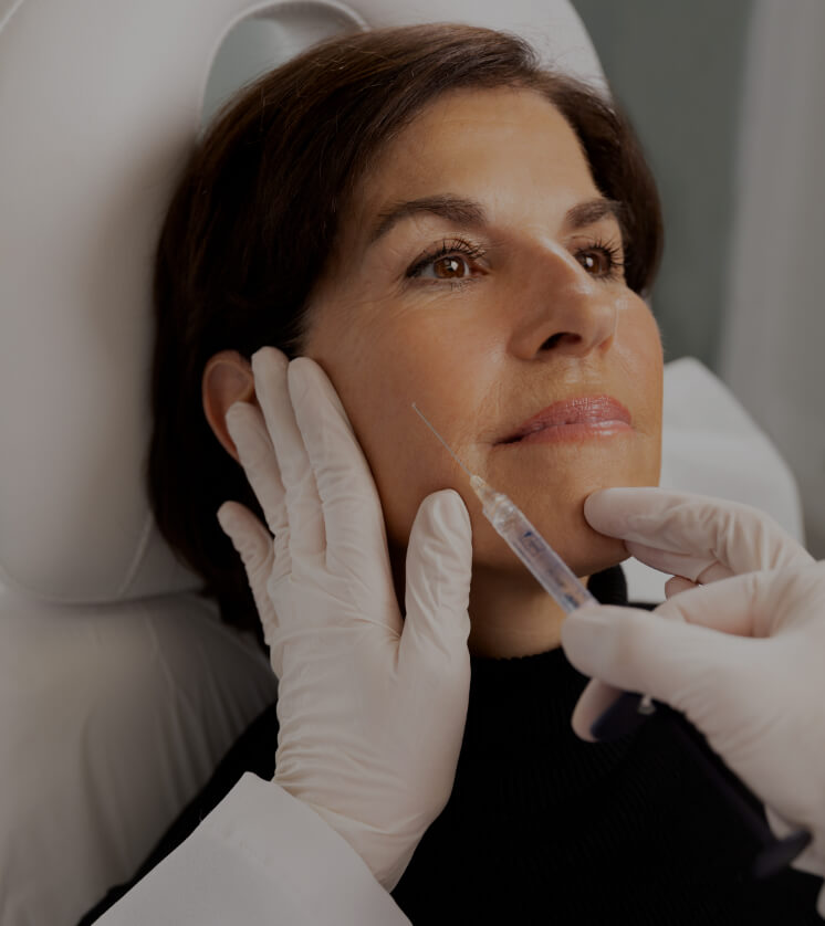 Dr. Chloé Sylvestre performing dermal filler injections in a female patient's cheekbones